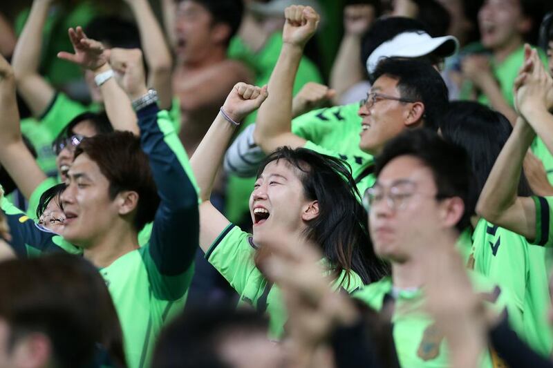 Jeonbuk Hyundai Motors supporters celebrate in the stands after their team won the Asian Champions League final. Pawan Singh / The National