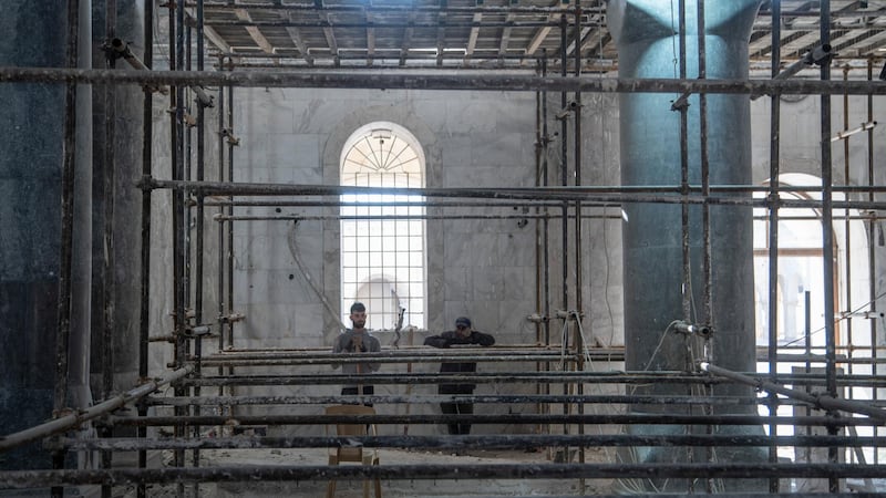 Workers taking a break during the restoration of Saint Mary Al Tahira church in Qaraqush, Mosul. Haider Husseini