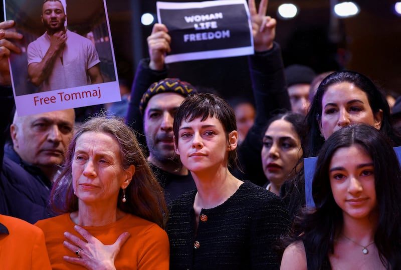 Berlinale director Mariette Rissenbeek, left, and actress Kristen Stewart, centre, demonstrate in solidarity with the protesters in Iran at the 73rd Berlinale International Film Festival in Germany on Saturday. Reuters