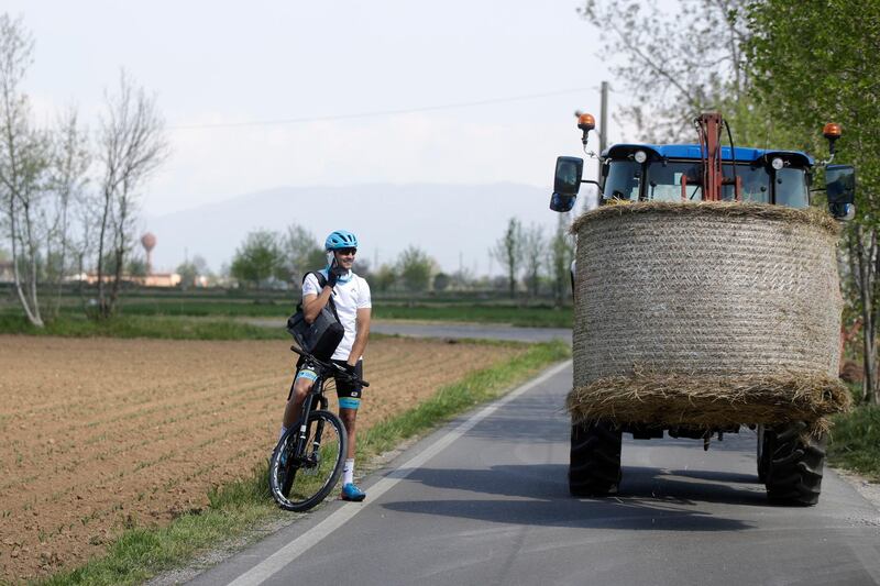 Davide Martinelli answers requests on his phone to deliver medicine to residents in Lodetto, near Brescia, Northern Italy. AP Photo