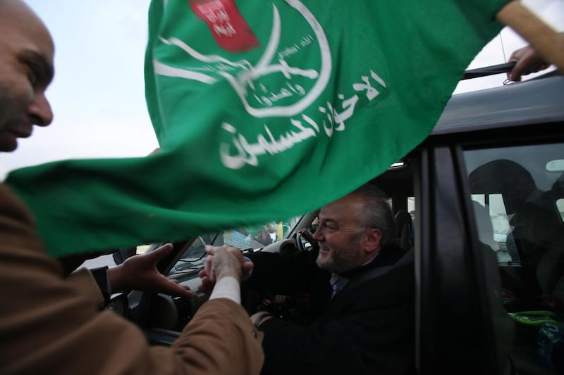 Jordanians great British MP George Galloway as they wave to the aid convoy with flags and throwing flowers on their way near the border between Jordan and Syria on December 29, 2009. (Salah Malkawi for The National)