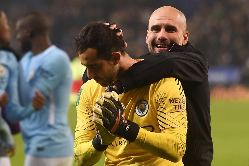 Manchester City's Spanish manager Pep Guardiola (R) celebrates on the pitch with Manchester City's Chilean goalkeeper Claudio Bravo (L) after winning after the penalty shoot out in the English League Cup quarter-final football match between Leicester City and Manchester City at King Power Stadium in Leicester, central England on December 19, 2017. (Photo by PAUL ELLIS / AFP) / RESTRICTED TO EDITORIAL USE. No use with unauthorized audio, video, data, fixture lists, club/league logos or 'live' services. Online in-match use limited to 75 images, no video emulation. No use in betting, games or single club/league/player publications. / 