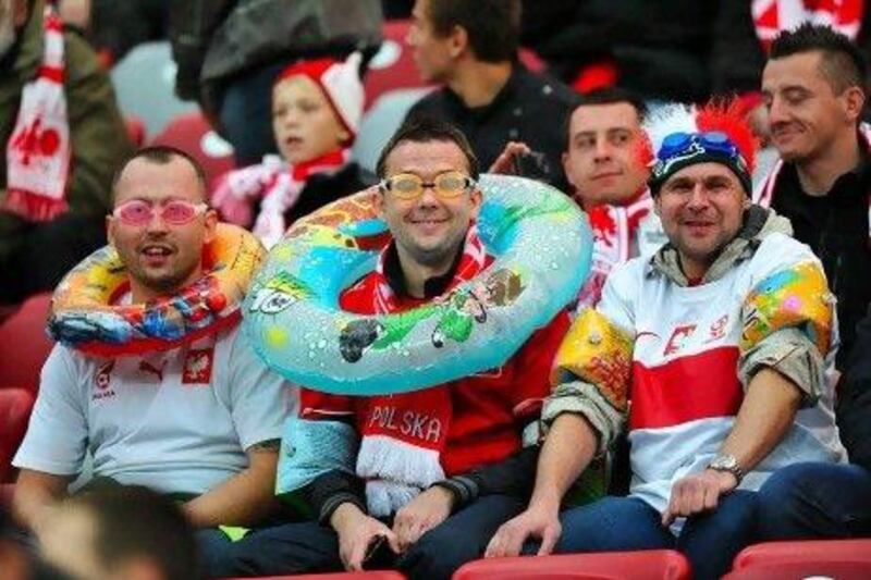 Polish fans wear aquatic equipment before the match against England.