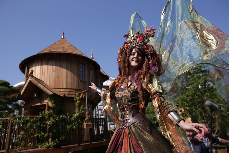 Performers pose in front of the Blue Forest Tree Houses.