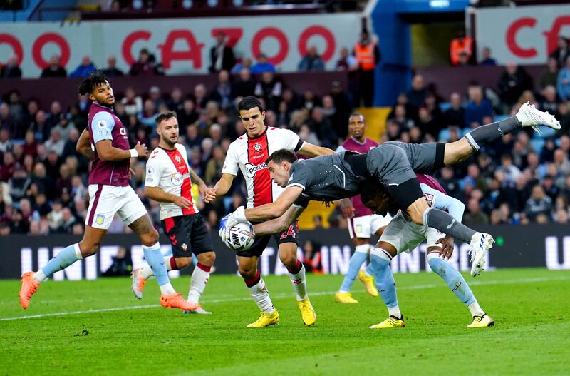 Aston Villa goalkeeper Emiliano Martinez battles for the ball at Villa Park. PA