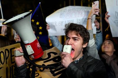 Right-wing demonstrators hold placards and shout slogans near the European Parliament headquarters in Madrid. AFP