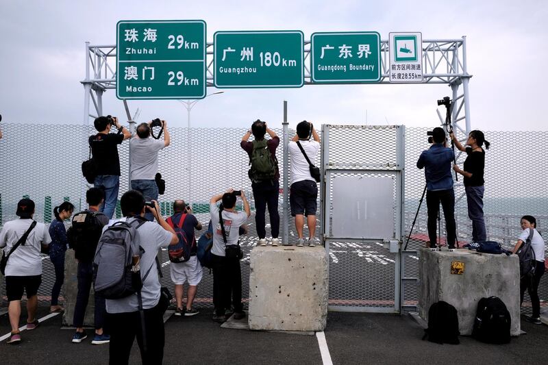Members of the press take pictures of the Hong Kong-Zhuhai-Macau bridge. Bobby Yip / Reuters