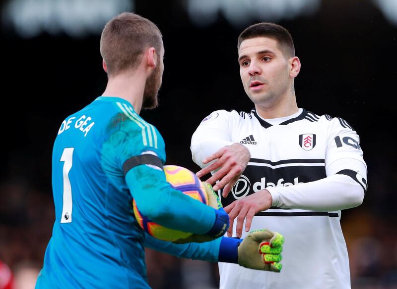 Fulham's Aleksandar Mitrovic clashes with Manchester United's David de Gea. Reuters