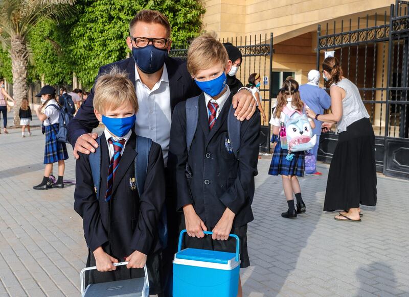 Abu Dhabi, United Arab Emirates, August 30, 2020.  Children return to school on Sunday after months off due to the Covid-19 pandemic at the Brighton College, Abu Dhabi. --  Stephen Haw and sons, Hugo, nine and Hector, seven.
Victor Besa /The National
Section:  NA
Reporter:  Haneen Dajani