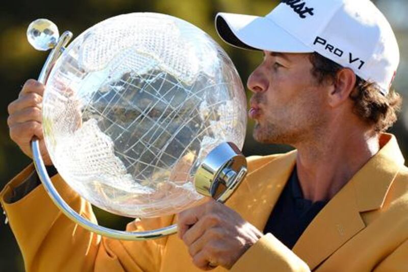 Adam Scott kisses the Australian Masters trophy after winning the tournament in Melbourne.