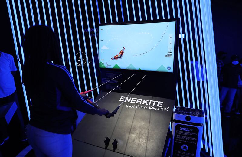 Visitors fly Enerkite at the Germany pavilion.