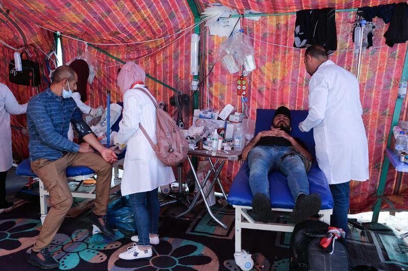 Volunteering medics tend to demonstrators in a makeshift clinic during an anti-government demonstrations in the capital Baghdad's Tahrir square. AFP