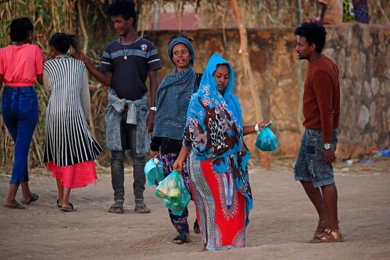 Ethiopian refugees who fled fighting in Tigray province, walk at the Um Rakuba camp in Sudan's eastern Gedaref province.  AFP