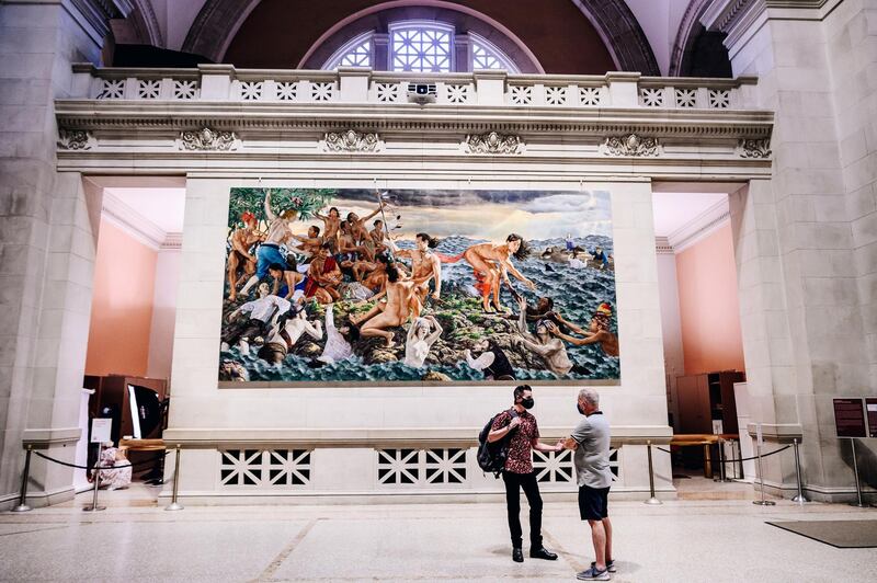 Visitors talk in front of a painting during the public reopening at the Metropolitan Museum of Art in New York, USA. Bloomberg