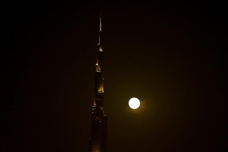 The full Moon rises next to Burj Khalifa in Dubai,. Reuters