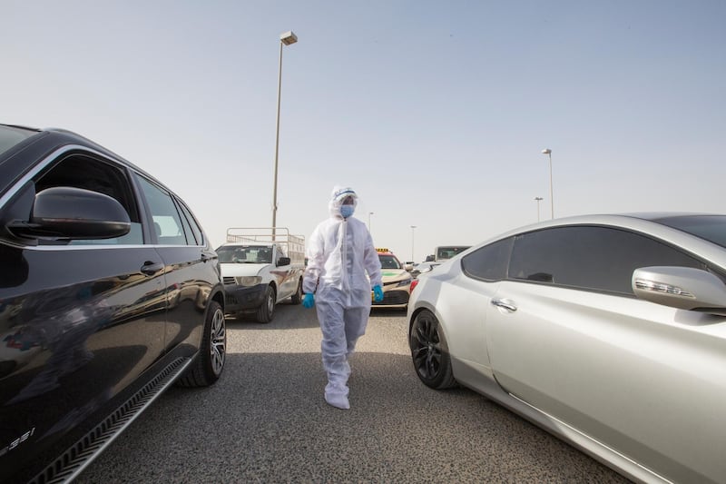 Dubai, United Arab Emirates - A staff from the testing centre answering query from people getting tested at the DPI Testing Centres border of Dubai and Abu Dhabi.  Leslie Pableo for The National for Shireena Al Nowais story