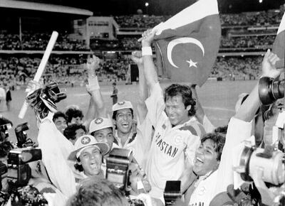 FILE - In this March 25, 1992 file photo, Pakistan's cricket captain Imran Khan, waving a Pakistan flag, is cheered by his teammates after Pakistan defeated England in the World Cup Cricket final, in Melbourne, Australia. On Thursday July 26, 2018, Khan's political party, Tehreek-e-Insaf (Movement of Justice), took a commanding lead in the Pakistan general election and he was set to become the first international cricketer in the world to be elected as a country's prime minister, considered the second toughest job in Pakistan. (AP Photo/Steve Holland, File)
