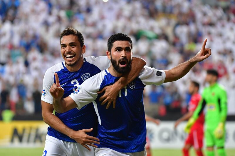 Al Hilal's forward Omar Khribin (R) celebrates with teammates after scoring during the first leg of their AFC Champions League semi-final football match at the Mohammed Bin Zayed Stadium in Abu Dhabi on September 26, 2017.  / AFP PHOTO / GIUSEPPE CACACE