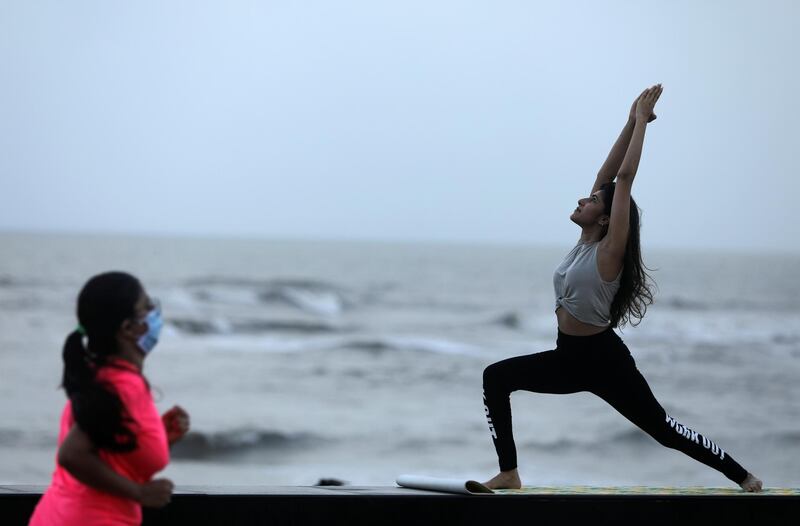 A woman does yoga at a promenade by the Arabian Sea in Mumbai. Reuters