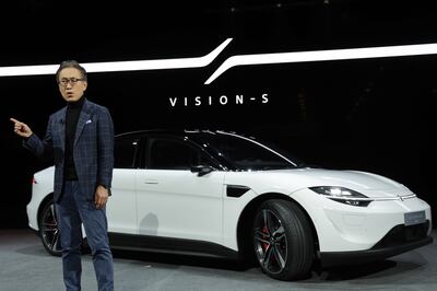 Kenichiro Yoshida, chairman and chief executive of the Sony Group, speaks as the Sony Vision-S 01 sedan is on display at CES 2022 in Las Vegas. AFP
