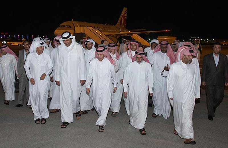 The Emir of Qatar Sheikh Tamim meets a number of people at Doha airport in April 2017 after their release from captivity in Iraq. Qatar reportedly paid hundreds of millions of dollars to an Iranian-backed Shiite militia that had kidnapped the 26 hostages in 2015. (Qatar News Agency via AP, File)