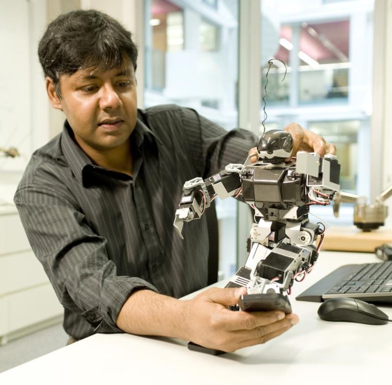 Professor Sethu Vijayakumar of the University of Edinburgh with a robot. Courtesy University of Edinburgh