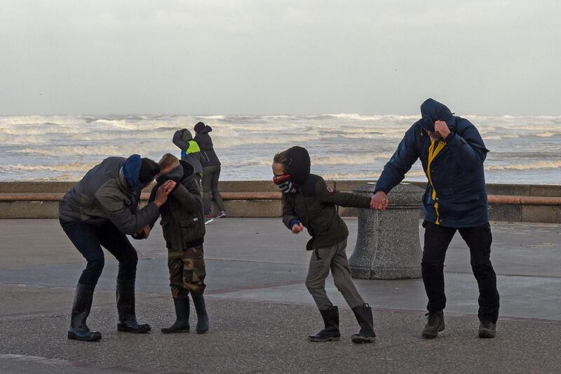 People brave the wind on the seafront of Wimereux, northern France. Francois Lo Presti / AFP Photo