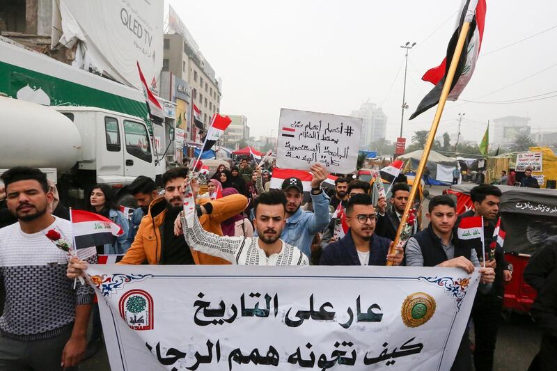 Iraqi protesters march during a anti-government protest in Tahrir square in the capital Baghdad, on December 15, 2019. Iraq's capital and Shiite-majority south have been gripped Since October 1, by rallies against corruption, poor public services, a lack of jobs and Iran's perceived political interference. / AFP / SABAH ARAR
