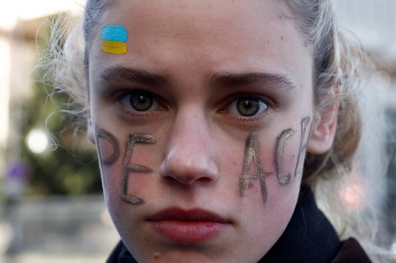 A woman takes part in an anti-war protest in front of the Russian embassy in Paris. AFP