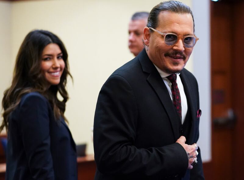 Depp arrives in the courtroom with Ms Vasquez. AP
