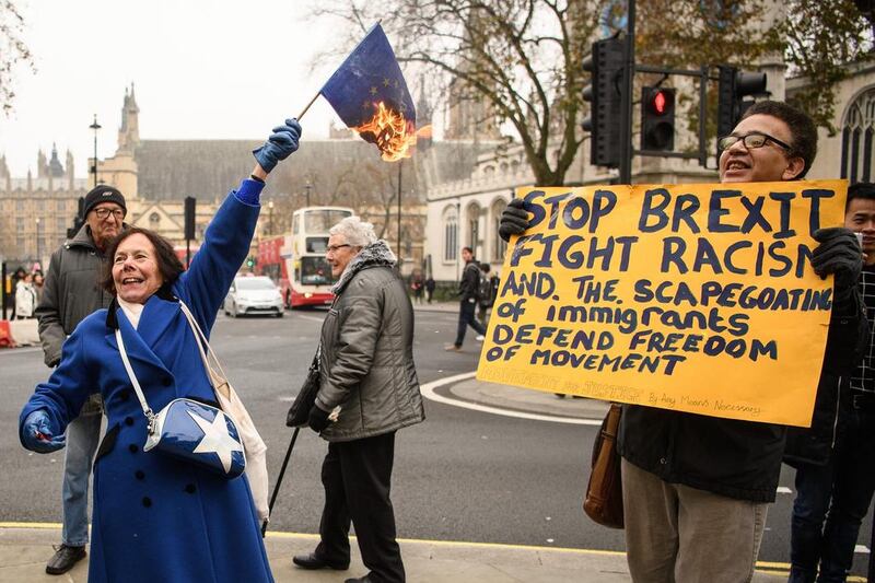 A woman burns an EU flag outside the Supreme Court on the second day of a hearing into whether Parliament's consent is required before the Brexit process can begin, on December 6, in London. Leon Neal / Getty Images