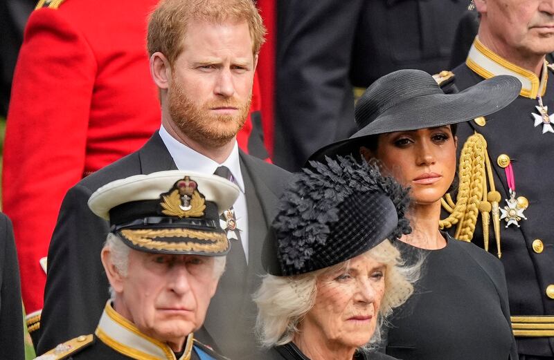 Prince Harry and Meghan watch as the coffin of Queen Elizabeth II is placed into the hearse following the state funeral service at Westminster Abbey in central London in September 2022. AP