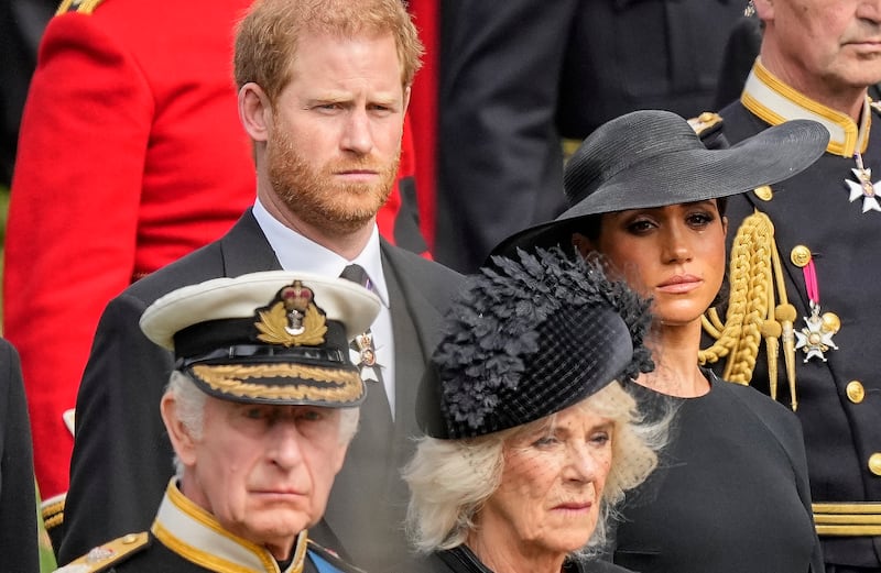 Prince Harry and Meghan watch as the coffin of Queen Elizabeth II is placed into the hearse following the state funeral service at Westminster Abbey in central London in September 2022. AP