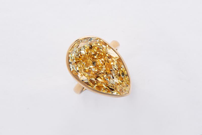 A light yellow pear-shaped diamond ring