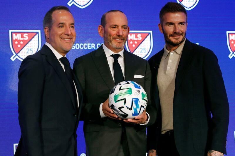 Inter Miami co-owners Jorge Mas, left, and David Beckham, right, pose for photos with Major League Soccer Commissioner Don Garber. AP