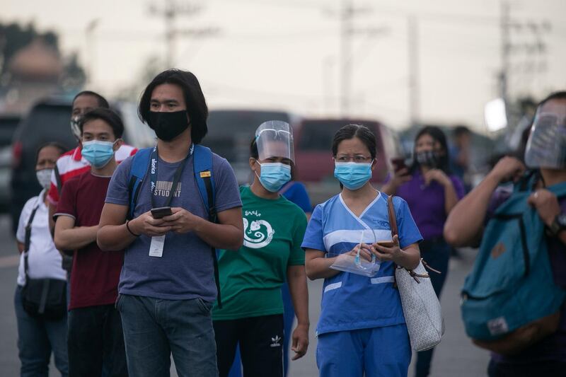 Stranded workers wait for shuttle services following the suspension of mass transportation on the first day of the government's reimplementation of a stricter lockdown to curb Covid-19 infections in Quezon City, Metro Manila, Philippines. Reuters