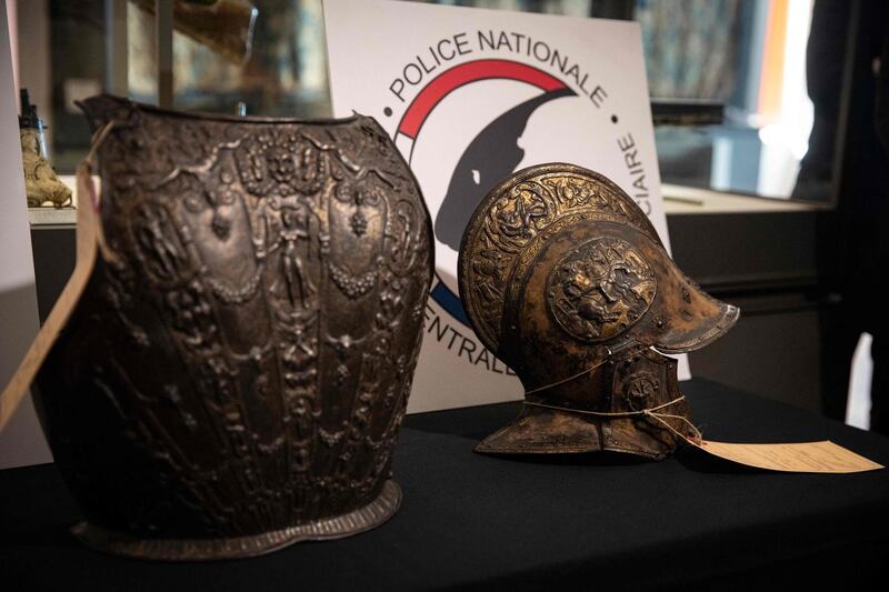 This picture taken on March 3, 2021, shows a breastplate and a ceremonial helmet during their official restitutions by the French Central Directorate of the Judicial Police (DCPJ) to the Louvre Museum, in Paris. A breastplate and a ceremonial helmet, two "exceptional" objects from the Italian Renaissance, were handed over by the police to the Louvre museum after being found in Bordeaux during an auction linked to an estate. These objects, which belonged to the collection of the Baroness de Rothschild, had been donated to the Louvre in 1922 and stolen in 1983. Estimations say they worth around 500,000 euros. / AFP / Thomas SAMSON
