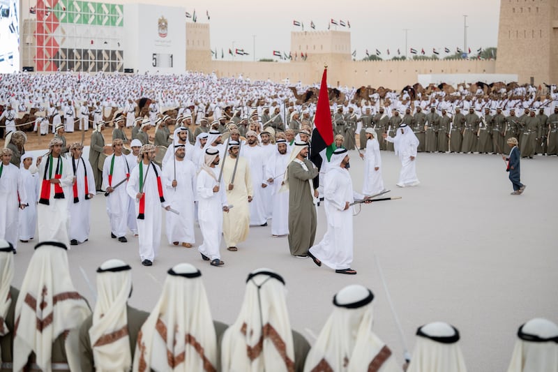Lt Gen Sheikh Saif bin Zayed, Deputy Prime Minister and Minister of Interior, and Sheikh Khalifa bin Tahnoun, Executive Director of the Martyrs' Families' Affairs Office,  participate in a traditional ayyala.  
Rashed Al Mansoori /  Presidential Court 