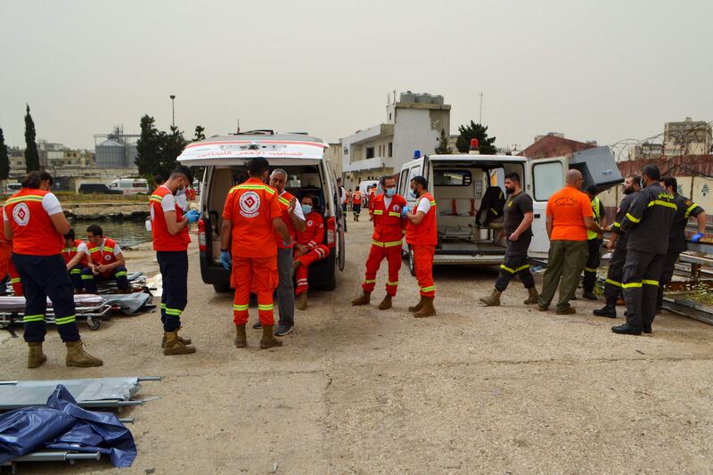 Medics wait on the pier as soldiers search for survivors off the coast of Tripoli, after an overloaded migrant boat capsized off north Lebanon during a chase by naval forces. AFP