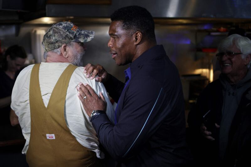 Georgia Republican Senate candidate Mr Walker greets local residents during a campaign stop in Dawsonville. Getty Images / AFP