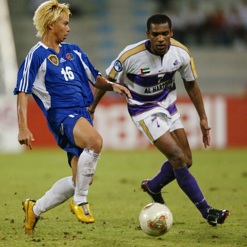 Sakchai Yuntasri of Bec Tero Sasana is checked by Mohd Omar Mohd of Al Ain (R) during the second leg of the AFC Champions League Final between Al Ain of UAE and Bec Tero Sasana of Thailand held at the Rajamangala National Stadium Bangkok, 11 October 2003. AFP PHOTO/Stanley Chou/WSG (Photo by STANLEY CHOU / WSG / AFP)