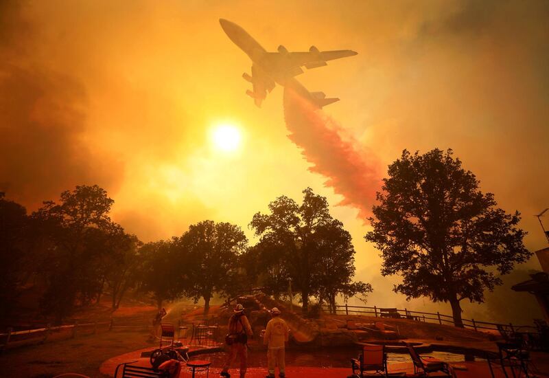A 747 Global Airtanker drops fire retardant during wildfires  in Lakeport, California. Kent Porter / The Press Democrat via AP