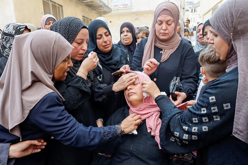 Mourners console the mother of Palestinian Mateen Dbaya, who was killed during an Israeli forces raid in Jenin refugee camp, during his funeral in the Israeli-occupied West Bank. Reuters