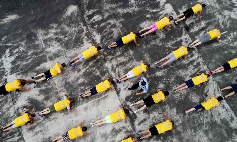 This photo taken shows drug addicts taking part in an exercise session as part of anti-drugs education at a drug rehabilitation centre in Liuzhou, in China's southern Guangxi region on International Anti-Drugs Day. AFP