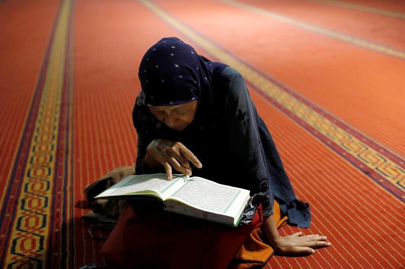 A muslim woman reads the Quran after morning prayer at Istiqlal mosque in Jakarta, Indonesia. Reuters
