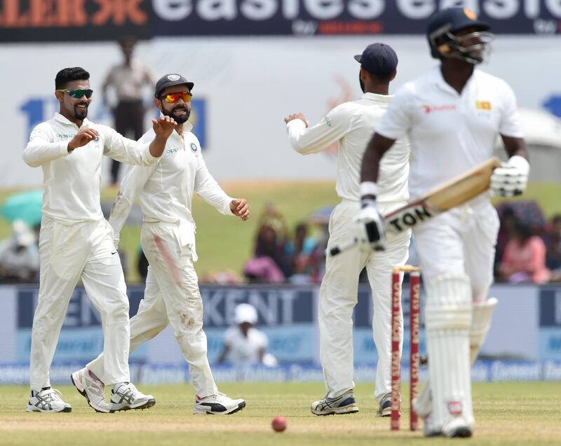 India celebrate the dismissal of Sri Lanka captain Angelo Mathews during the fourth day of the first Test at Galle on Saturday. Ishara Kodikara / AFP