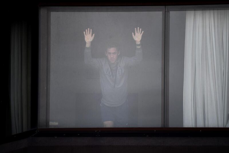 A tennis player waits in his hotel for a training session in Melbourne on January 19, 2021, as players train while quaratining for two weeks ahead of the Australian Open tennis tournament. AFP