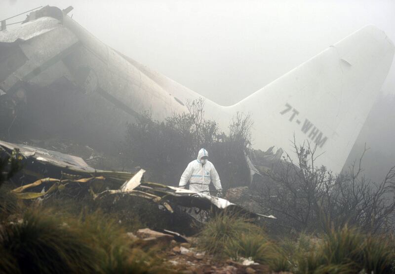 Forensic experts inspect the wreckage of a C-130 Hercules aircraft on Mount Fertas in the Oum El Bouaghi region, about 320 kilometres from the Algerian capital Algiers, on February 12, 2014. The military aircraft carrying 78 people crashed in the mountainous north-east region of the country on Tuesday, leaving a sole survivor in one of the country’s deadliest air disasters, the defence ministry said. Farouk Batiche / AFP photo