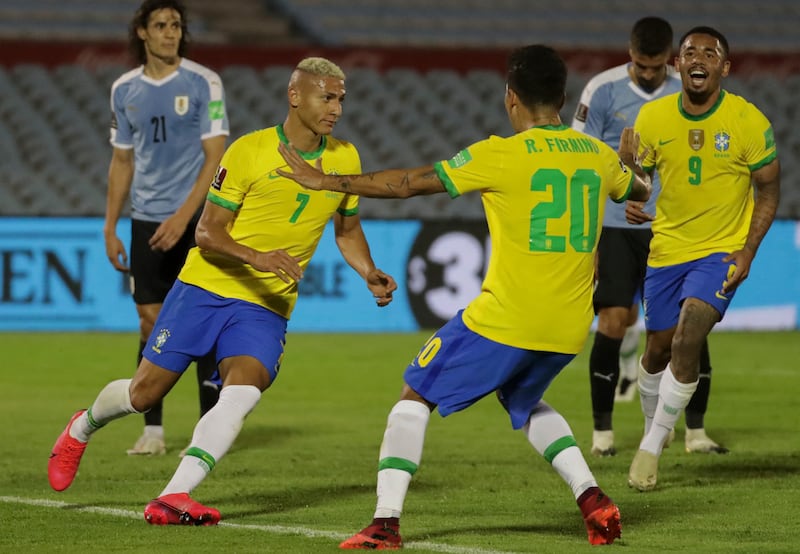 Brazil's Richarlison, left, celebrates with teammates Roberto Firmino and Gabriel Jesus after scoring against Uruguay during their 2022 World Cup South American qualifier. AFP