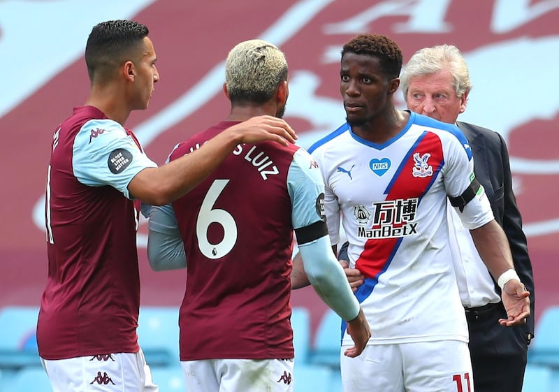BIRMINGHAM, ENGLAND - JULY 12: Douglas Luiz of Aston Villa speaks with Wilfried Zaha of Crystal Palace after the Premier League match between Aston Villa and Crystal Palace at Villa Park on July 12, 2020 in Birmingham, England. Football Stadiums around Europe remain empty due to the Coronavirus Pandemic as Government social distancing laws prohibit fans inside venues resulting in all fixtures being played behind closed doors. (Photo by Catherine Ivill/Getty Images)